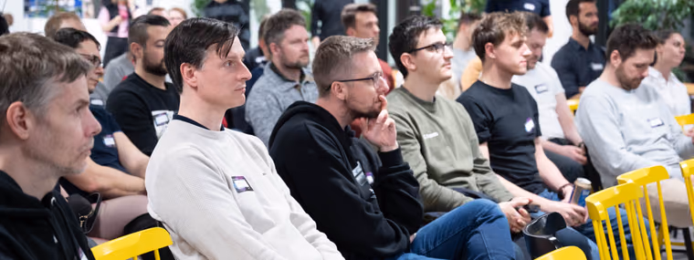 A seated audience listening to a talk at an ELC meetup in Brno