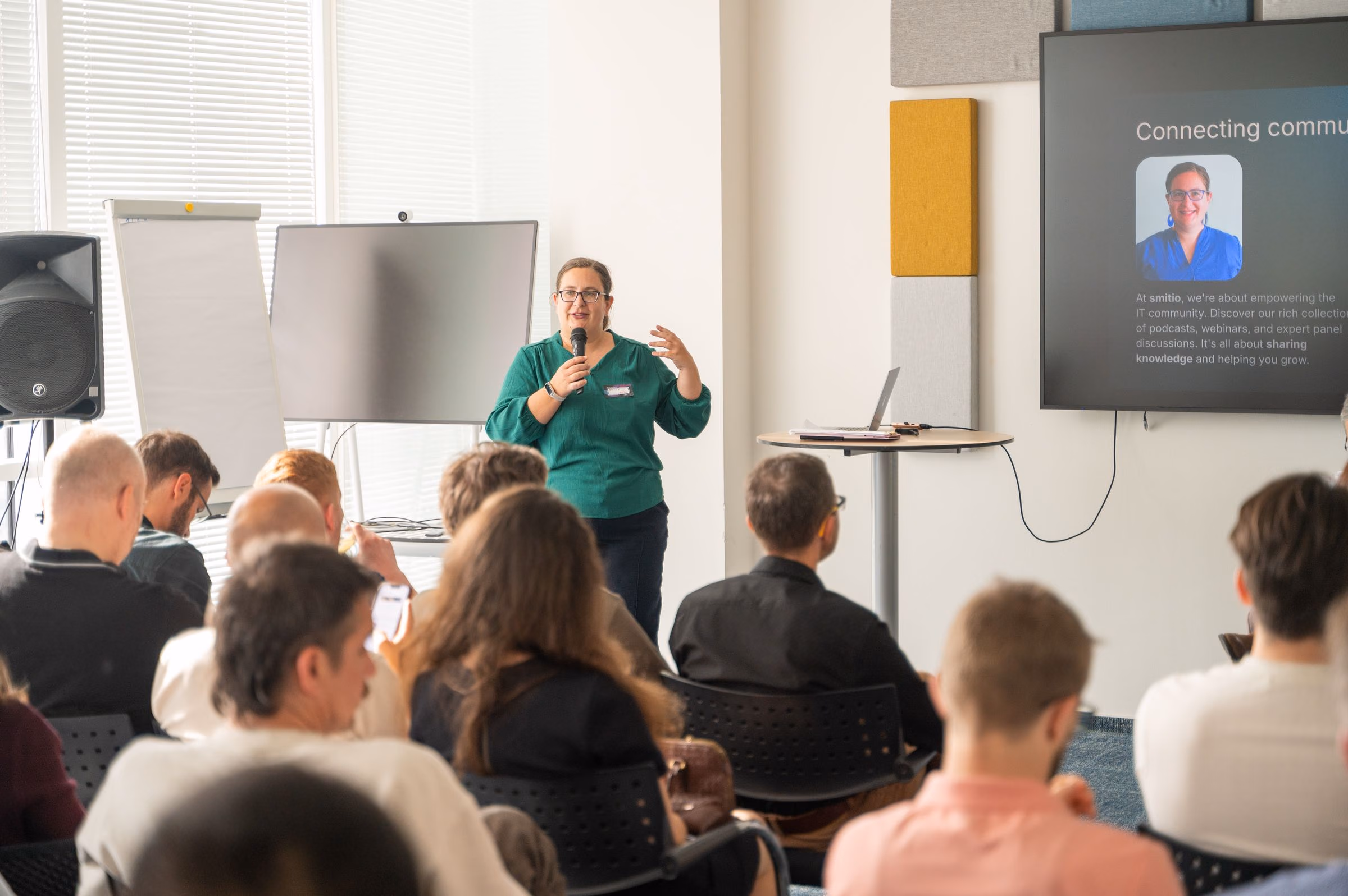 A speaker taking the floor in front of a full room at an ELC meetup