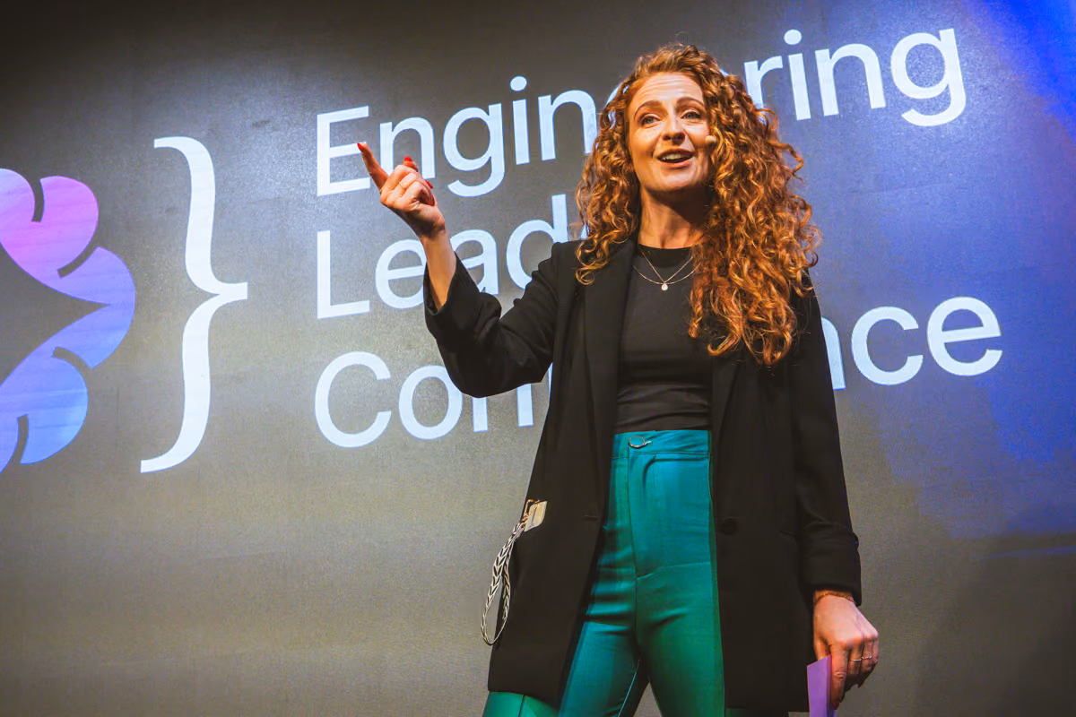 A speaker in a black blazer gesturing mid-talk on the ELC Conference stage in front of the Engineering Leaders banner
