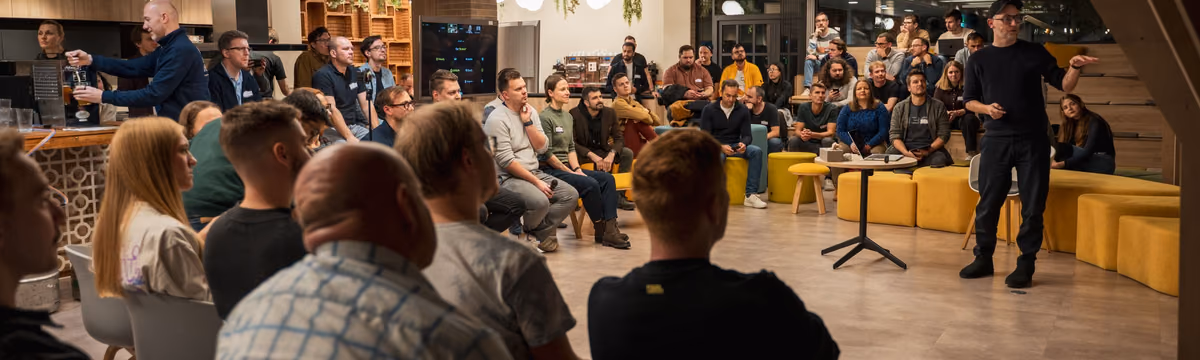 A packed ELC meetup, the room full and the speaker taking the floor