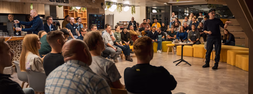 A packed ELC meetup in Prague, the room full and the speaker taking the floor