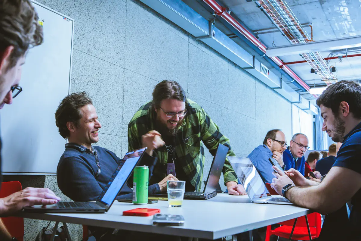 Engineering managers around a table full of open laptops during an ELC workshop, the people who lead teams and their AI agents
