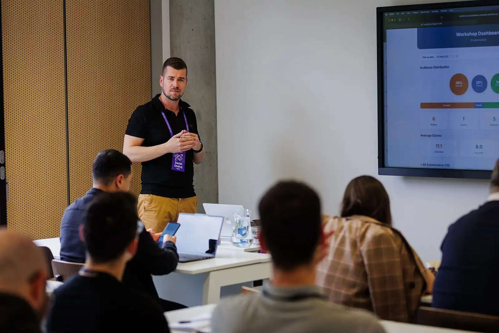 A speaker leading a session for leaders in a workshop room.