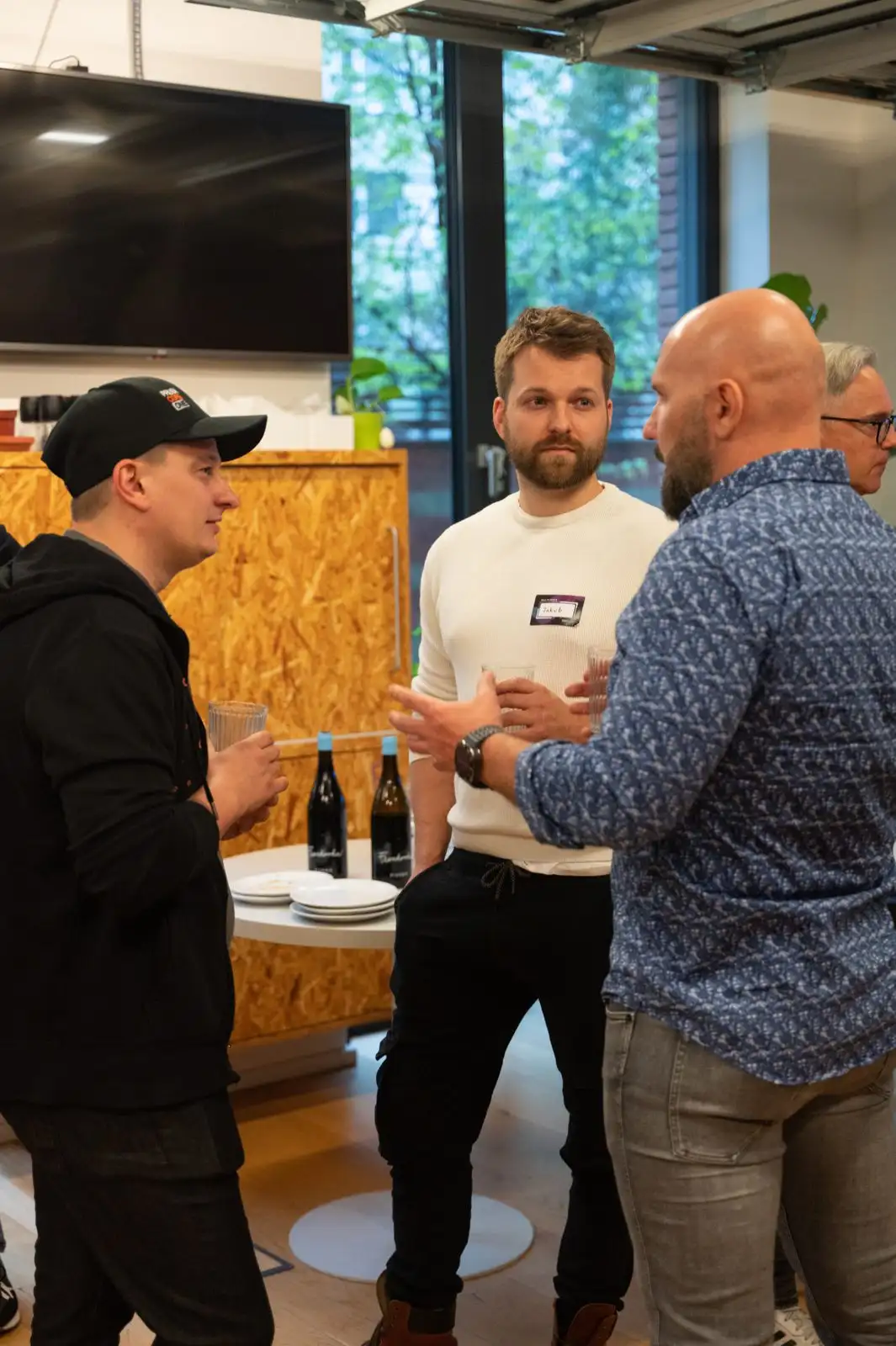Three engineering leaders in conversation during the networking part of an ELC meetup.