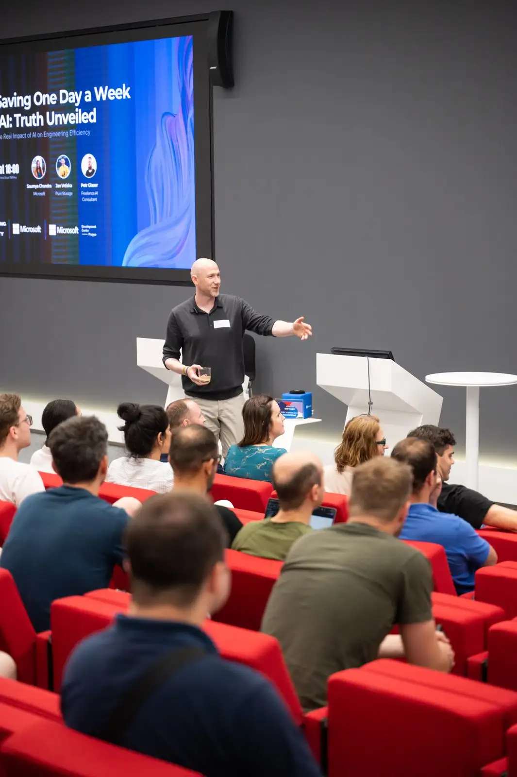 A speaker presenting to a full auditorium at an ELC meetup at Microsoft.