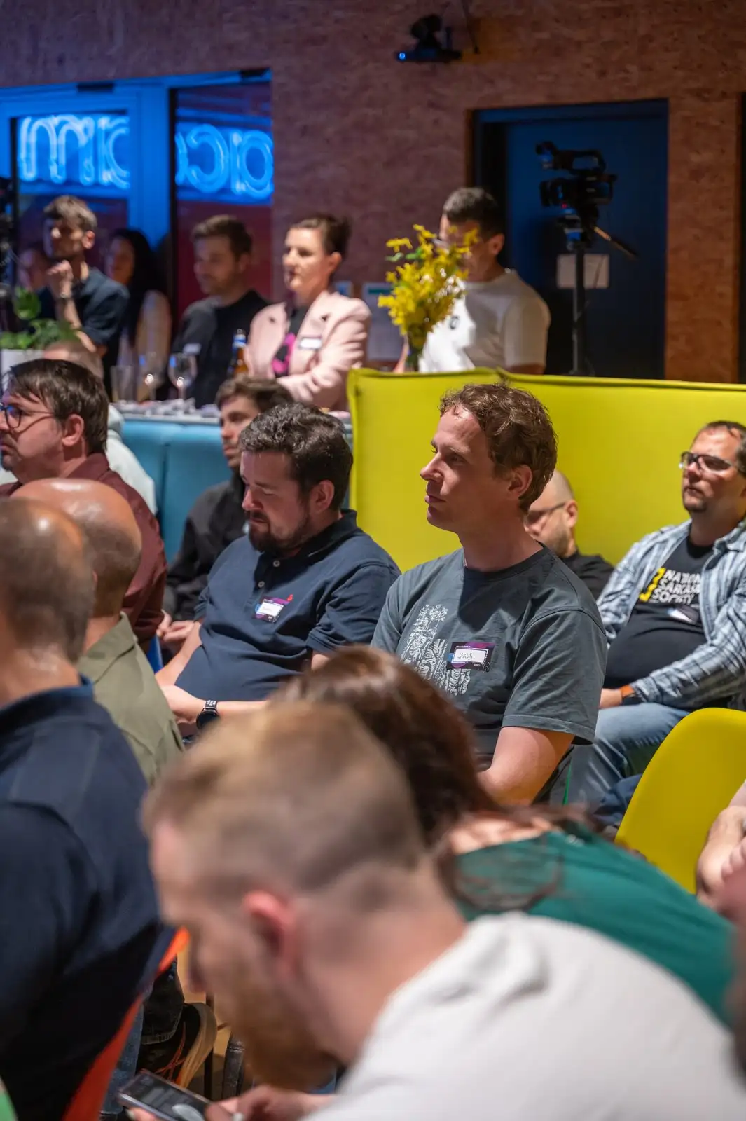 Engineering leaders smiling in the audience at an ELC meetup.