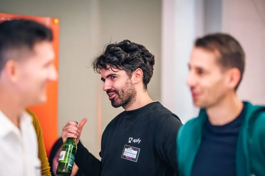 Marek Trunkát, CTO of Apify, talking with engineers at an ELC meetup