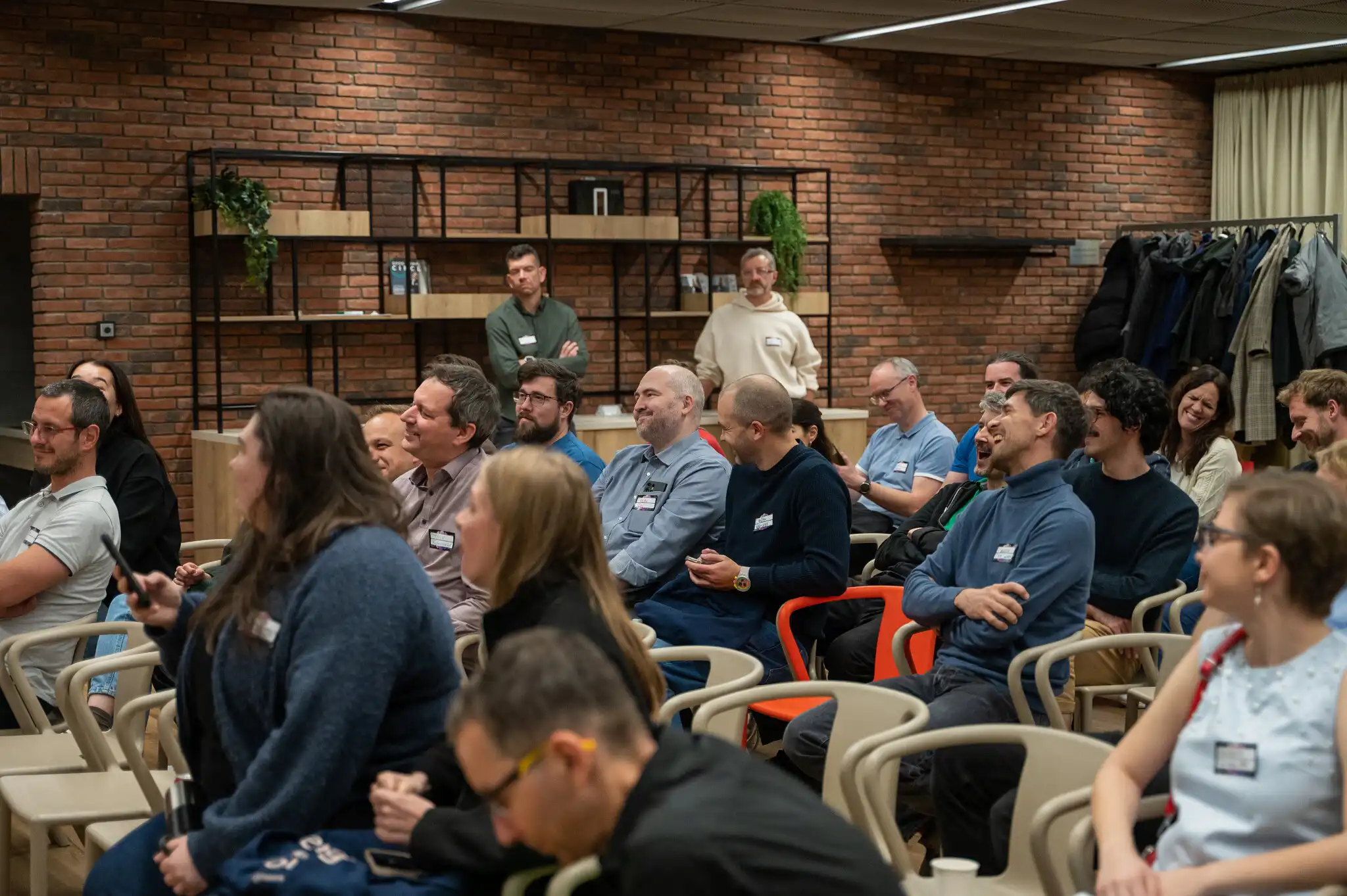 Engineering leaders laughing in the audience at an ELC meetup, the people the Leaders Brief newsletter lands with every month