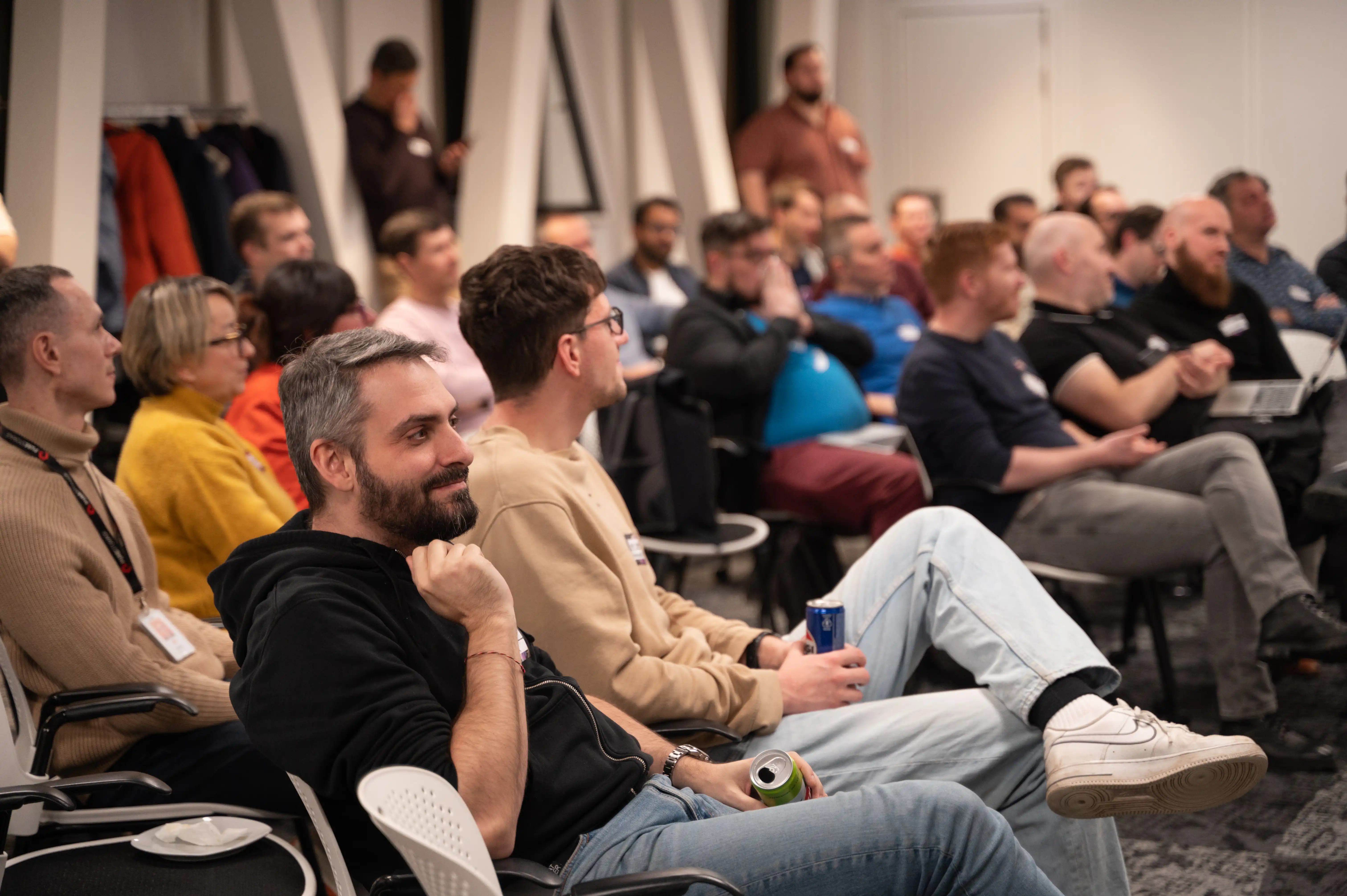A full room of seated engineering leaders watching a talk at an ELC meetup hosted in a company office