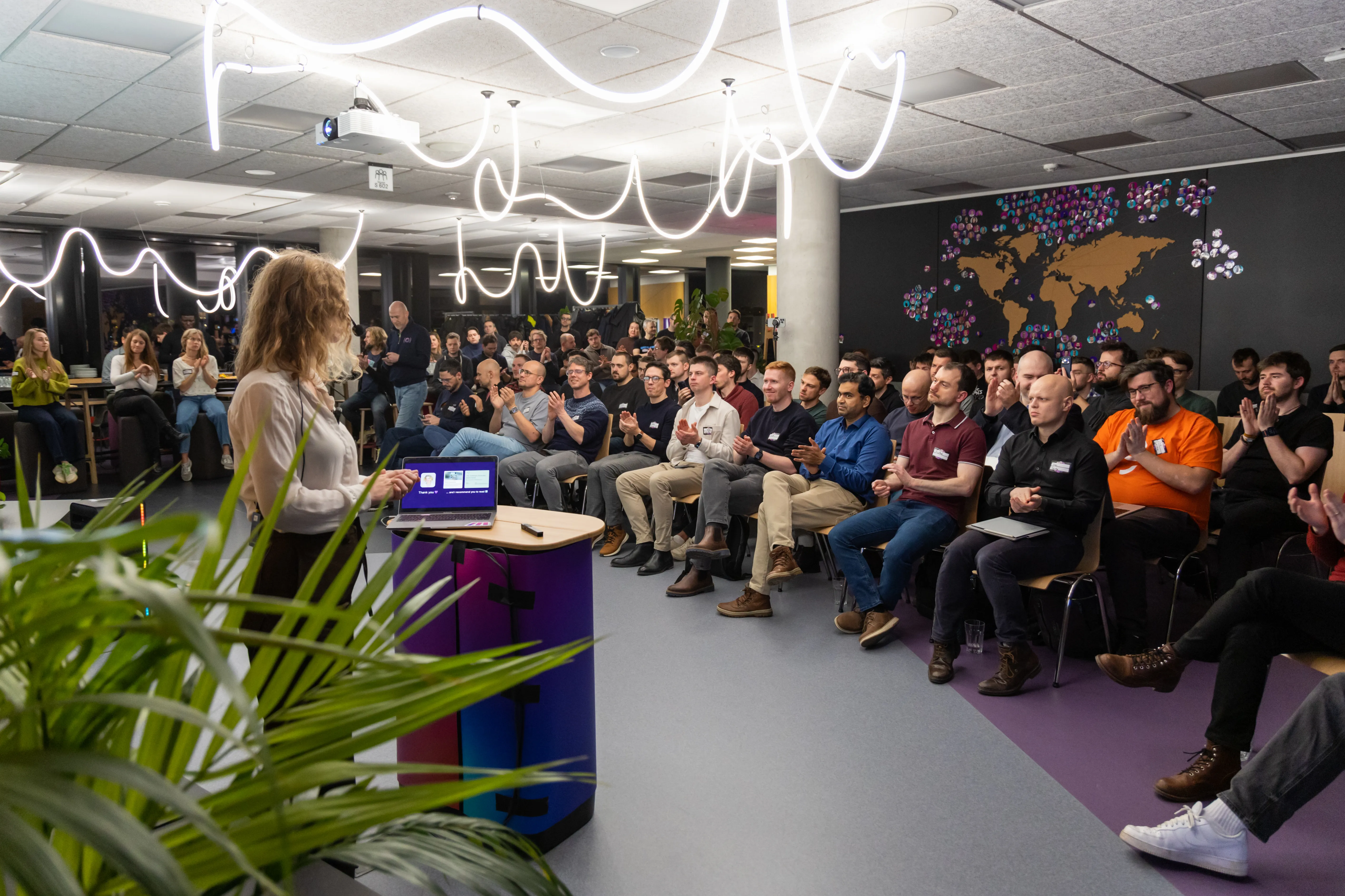 A packed ELC meetup, 120+ engineering leaders applauding a speaker