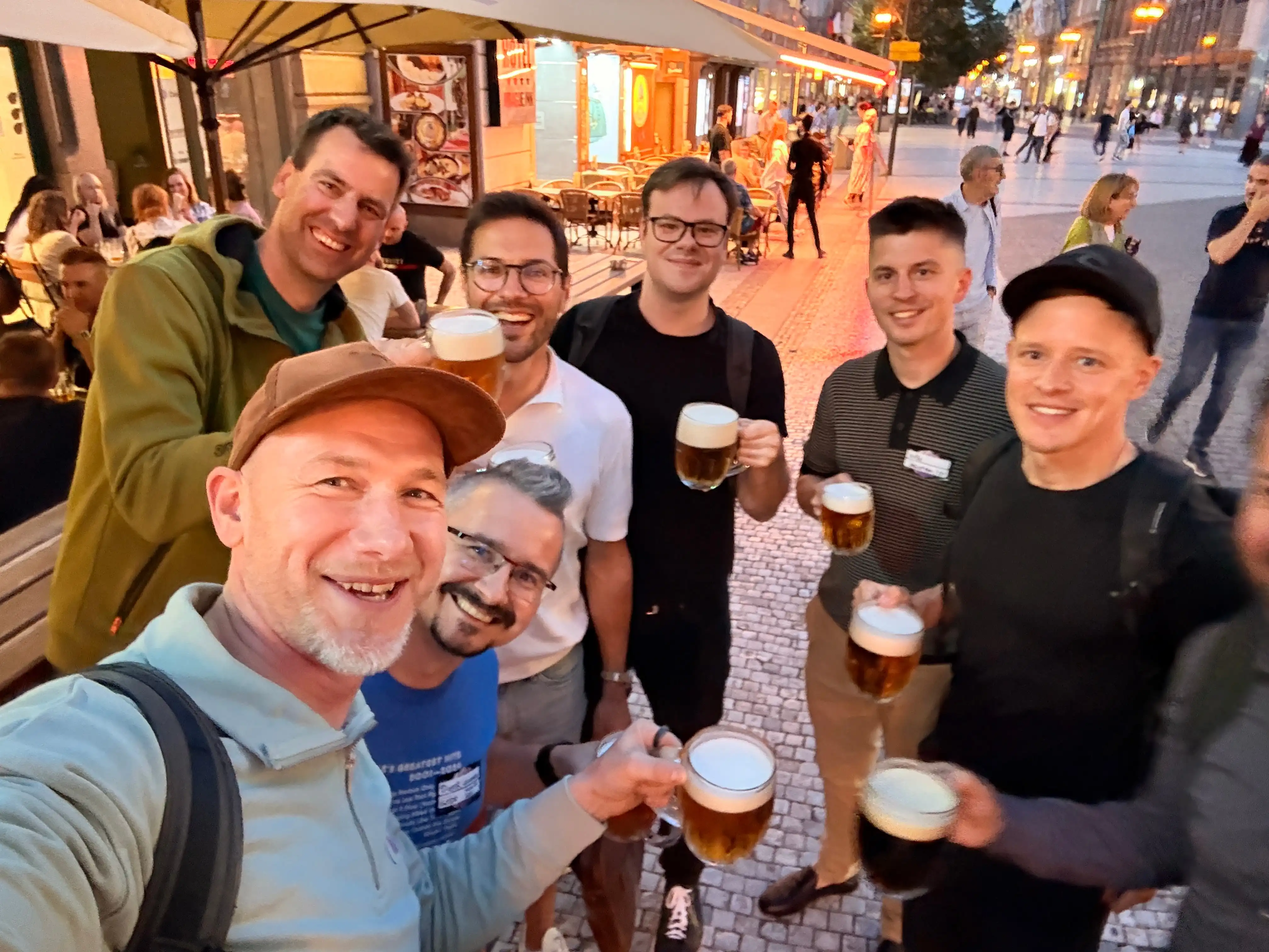 ELC members raising glasses together on a Prague street after a meetup