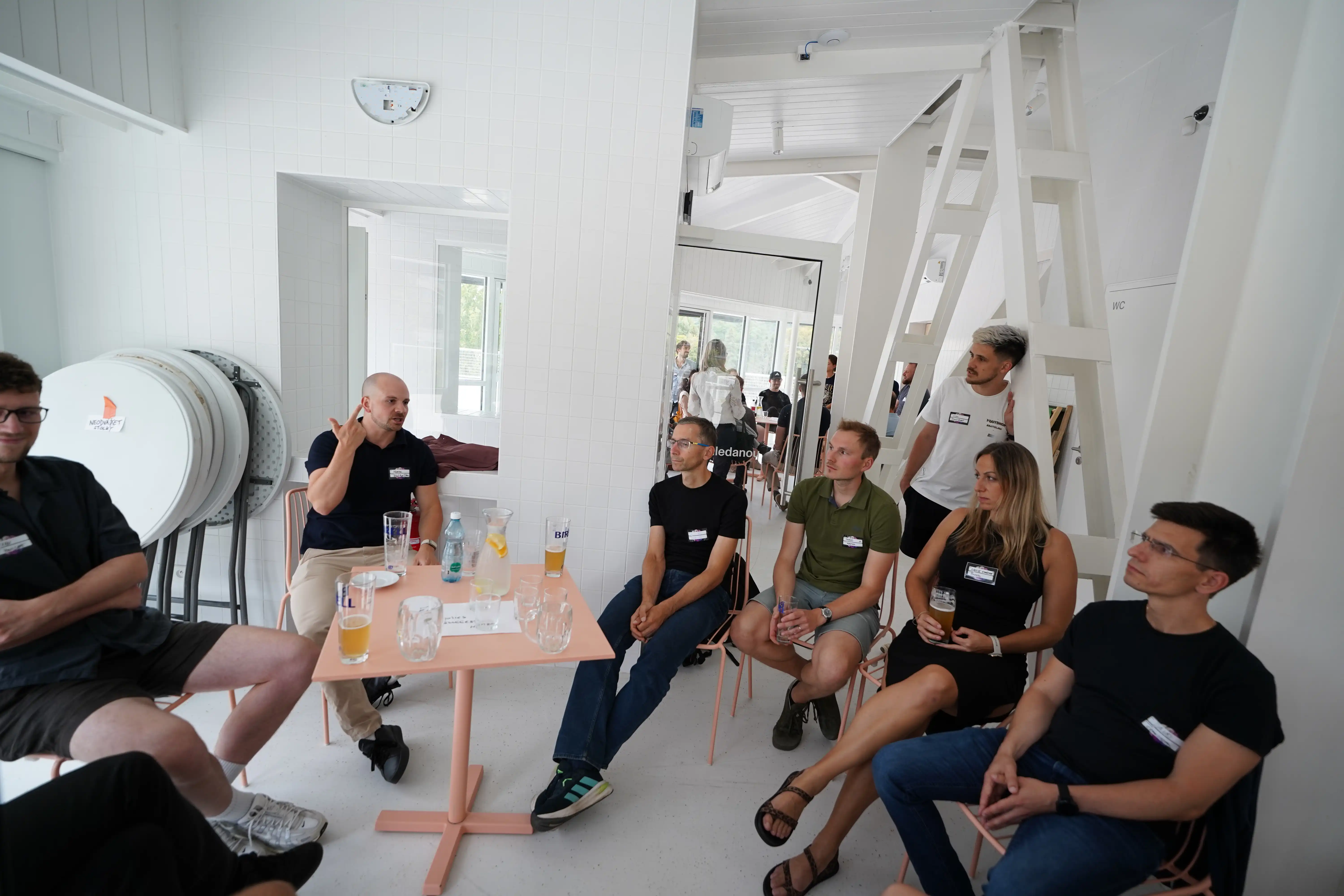 A small group of engineering leaders seated around a table in a working session, one of them presenting