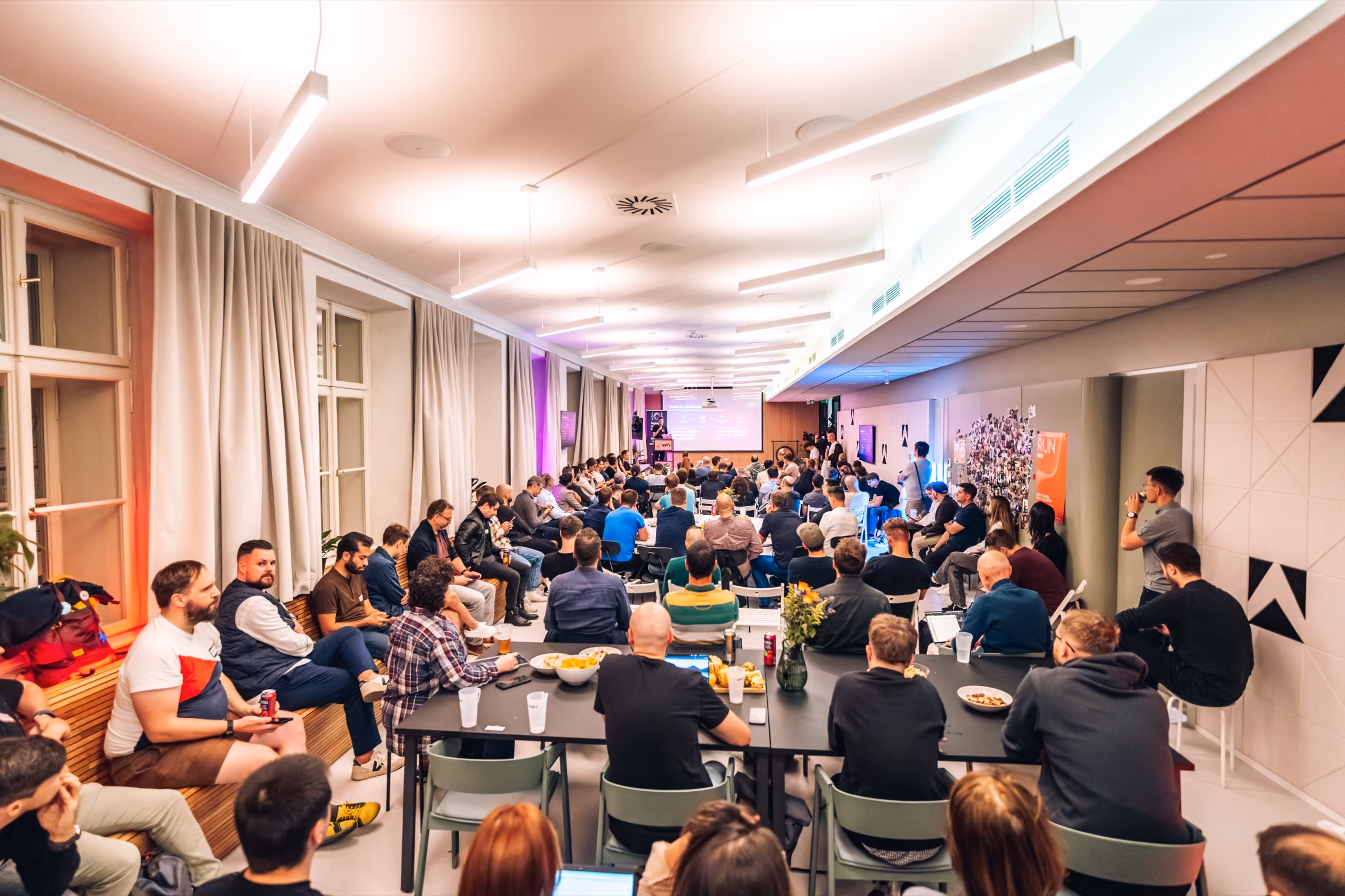 The full room at ELC meetup #43 at the Apify office in Prague, long tables of engineering leaders facing the screen