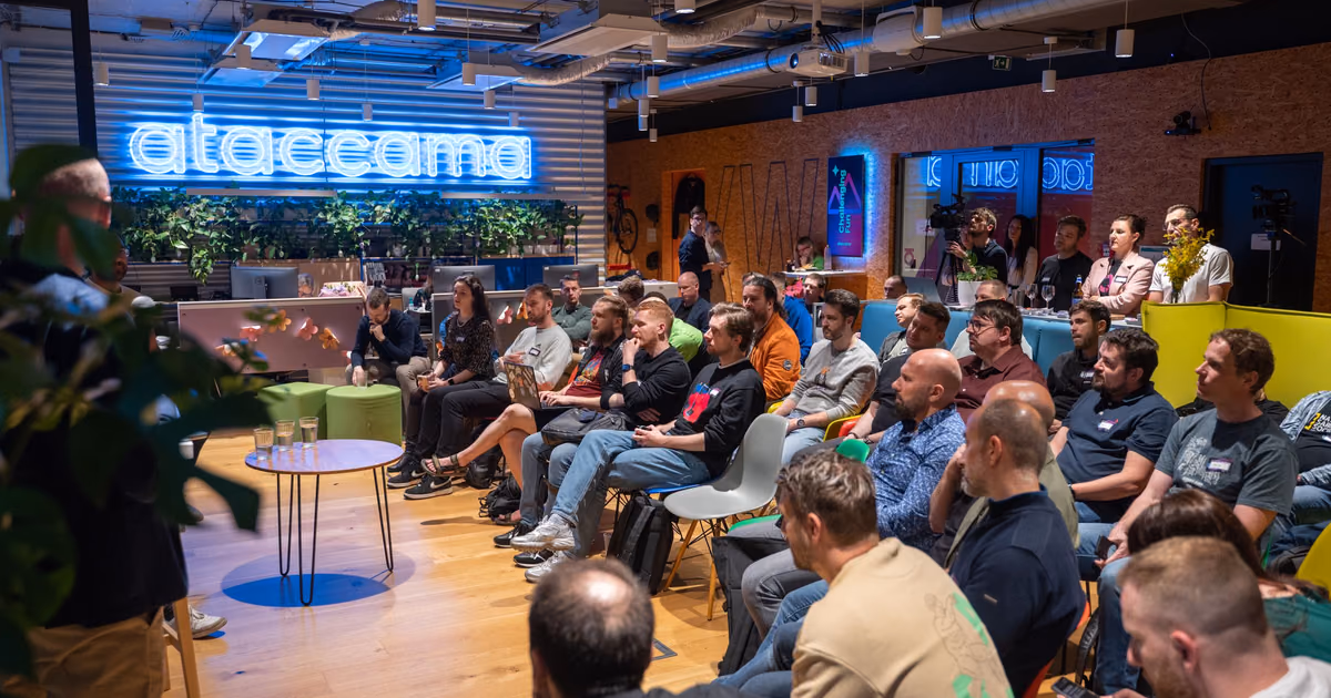 A full ELC meetup room with the host partner's brand lit above it
