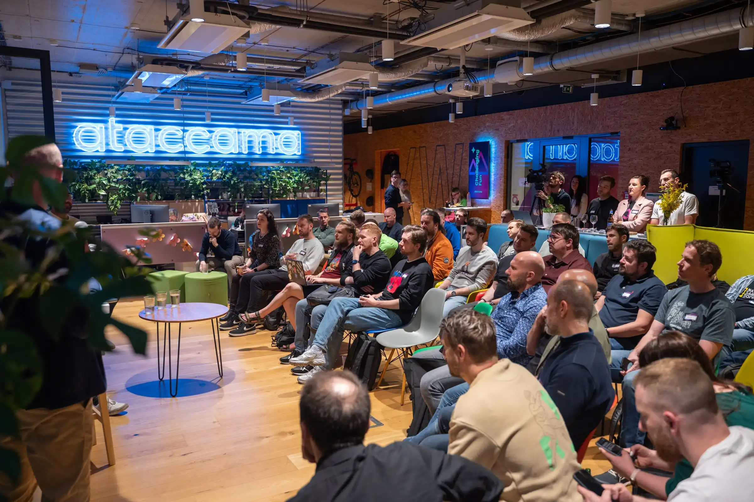 An ELC meetup filling the Ataccama office, a company member hosting the whole room