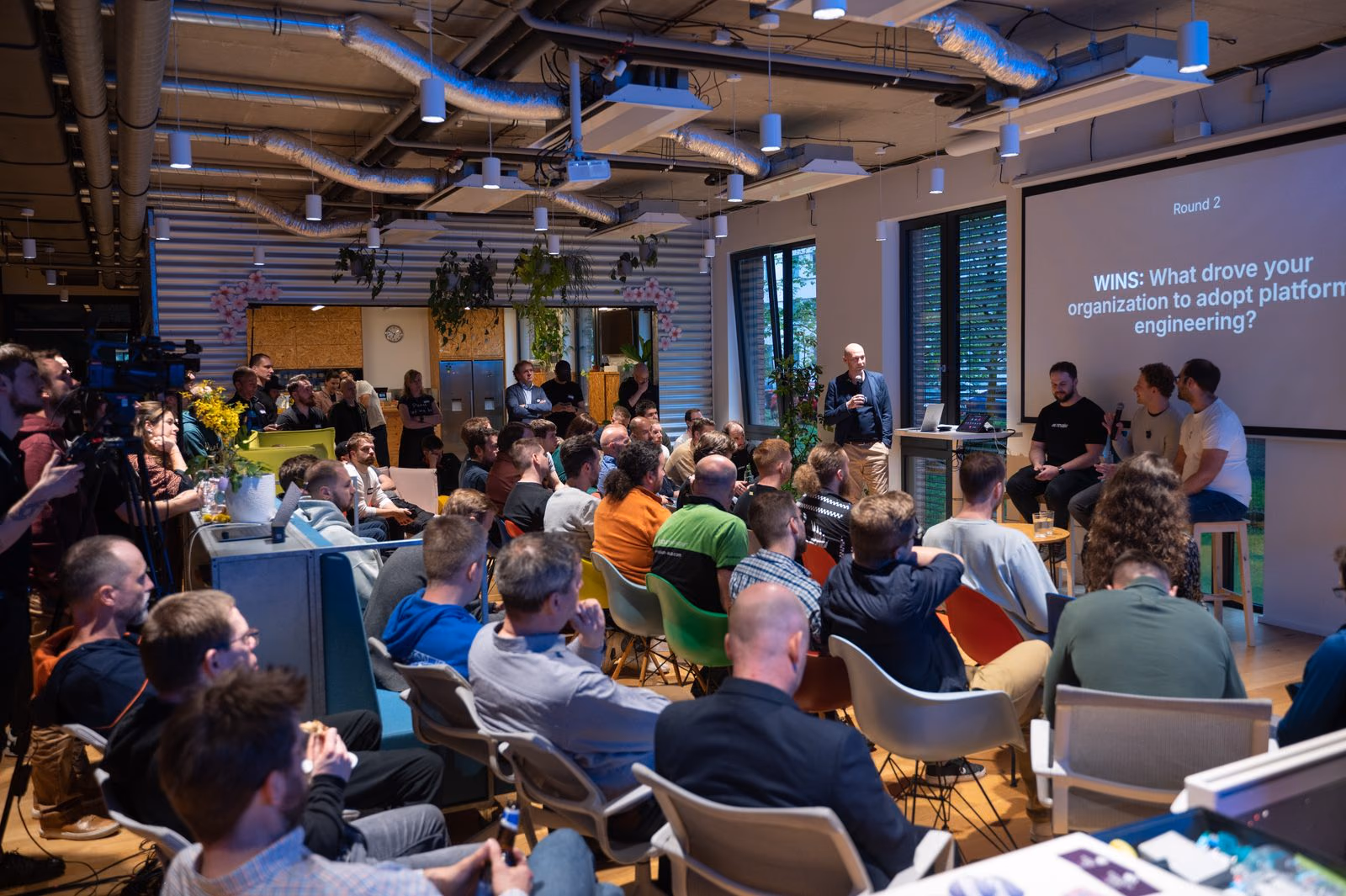 A full room at an ELC meetup at Ataccama in Prague, the audience listening to a panel.