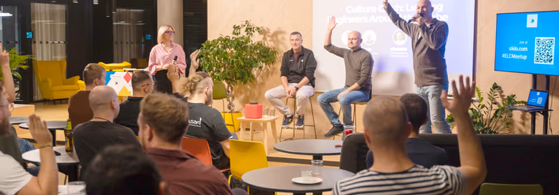 Panel discussion at an ELC meetup, the slide reading Culture Clash: Leading Engineers Around the Globe, with audience members raising hands to ask questions.