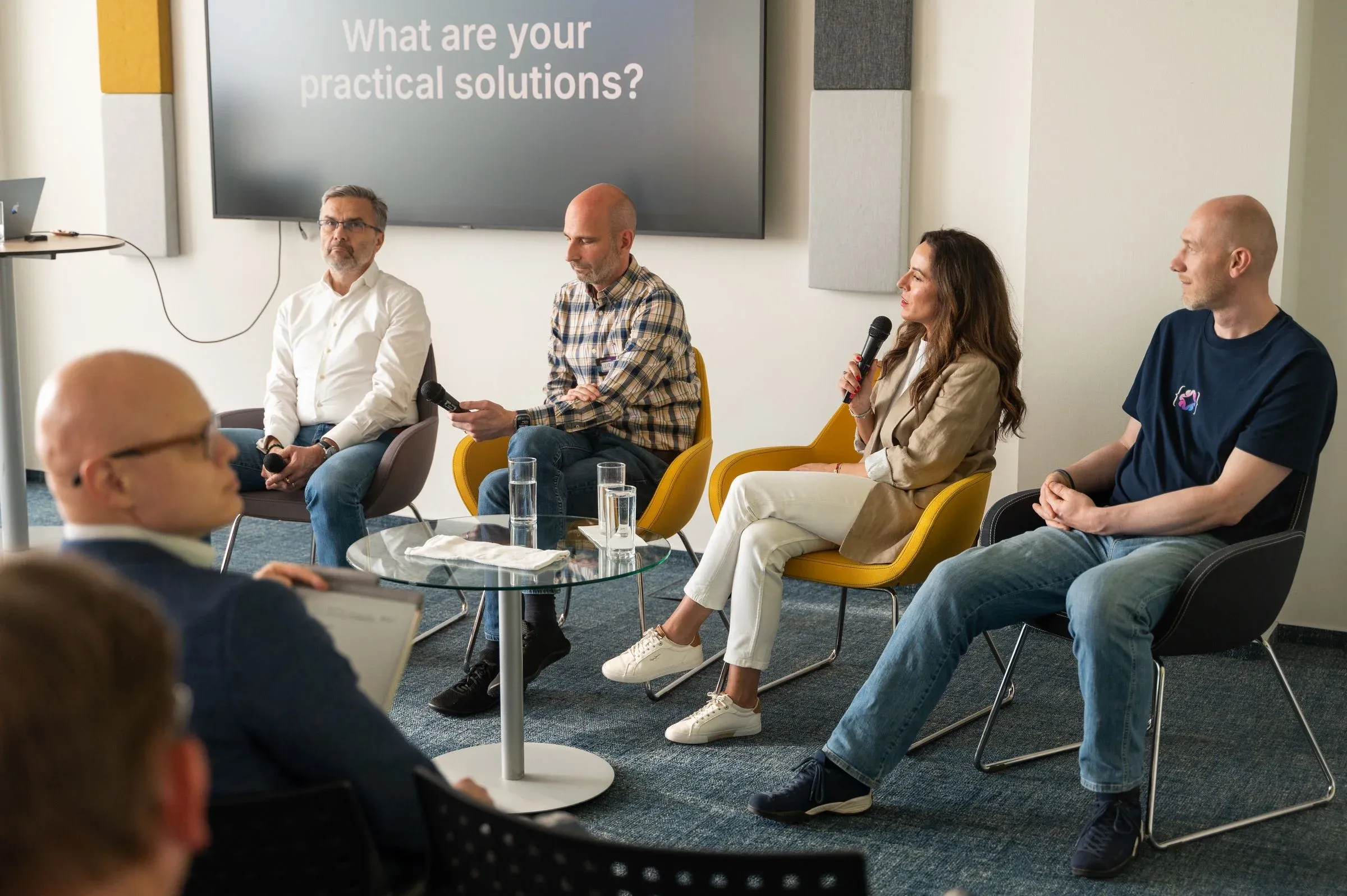 Five engineering leaders on a panel taking questions from the room at an ELC session